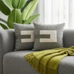 Modern Grey Woven Throw Pillow with Sherpa Patch and Faux Leather Strap Accent.